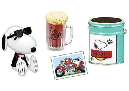 a collection of cartoon-themed items, including a Snoopy figurine, a root beer mug, a can of root beer, and a picture of Snoopy on a motorcycle.