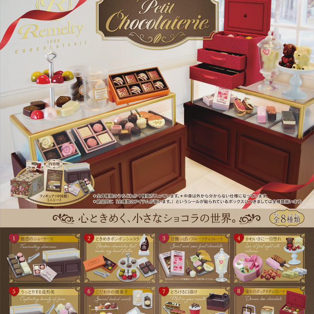 Miniature chocolate shop display with counters, open cases, and red register