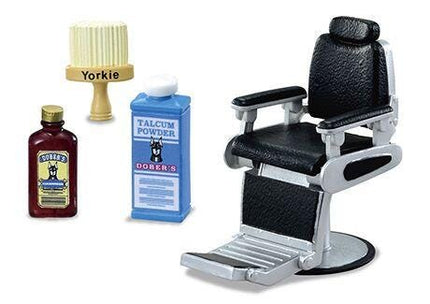 A barber's chair, a bottle of Yorkie, a bottle of Talcum Powder, and a brush are arranged in the image.