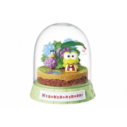 A figurine of Keroko Keroppi, a character from the Keroko series, is displayed in a glass dome.
