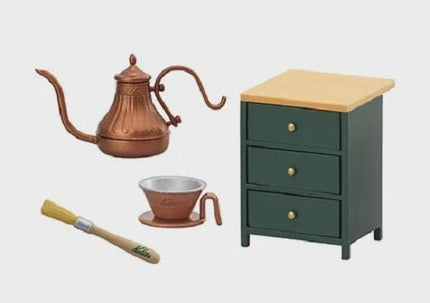 a copper teapot, a green wooden cabinet with three drawers, a small brown cup, and a yellow brush.