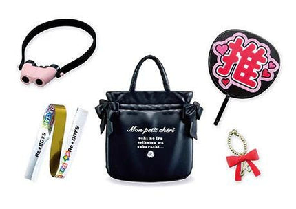 a variety of items, including a pink and black headband, a black handbag, a pink and black fan, a white and gold bracelet, a black and red charm, and a black and pink sign with a heart symbol.