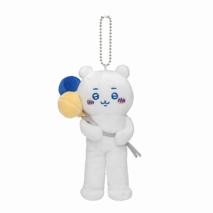 Mini plush mascot with blue face details, holding small gray accessory, hanging chain