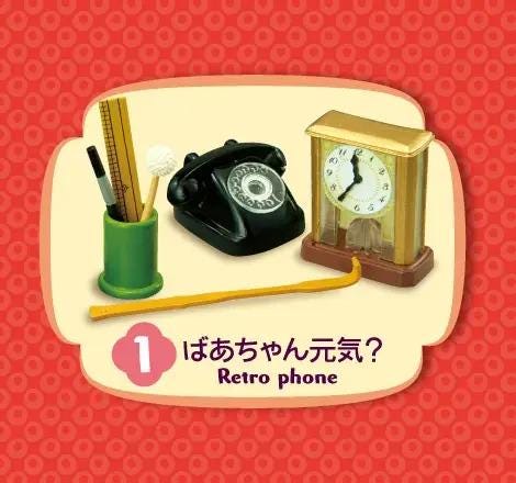 A retro-style clock, a green pencil holder, and a black telephone are displayed against a red background.