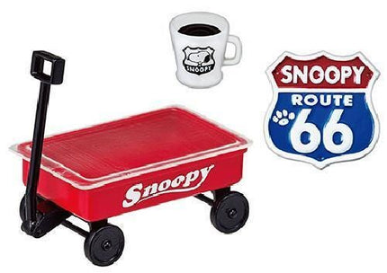 a red wagon with the word "Snoopy" written on it, a white mug with a black design, and a Route 66 sign.