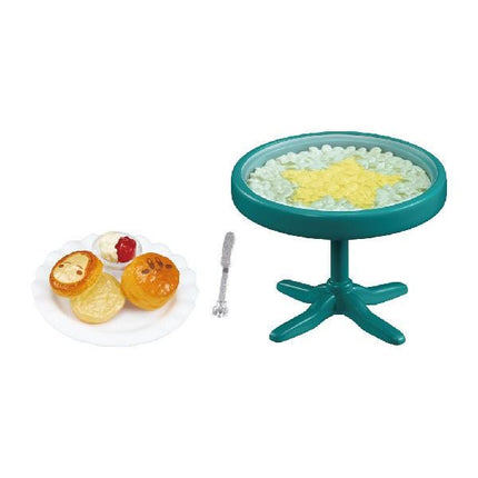 a plate of pastries and a teal-colored table with a star-shaped design on it.