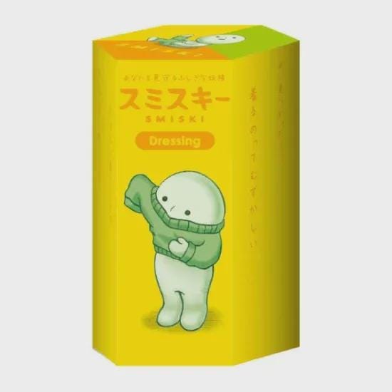 a yellow box with a cartoon character wearing a green sweater and holding a green object.