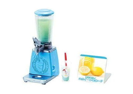 A blue and silver blender with a green liquid inside, a plastic cup with a straw, and a sign featuring lemons.