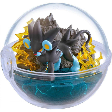 A Pokémon figurine is displayed inside a transparent glass ball containing a blue-green liquid and surrounded by yellow lightning bolts.