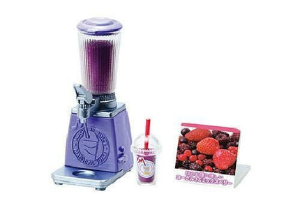 A purple blender with a clear plastic cup and a picture of berries on a stand.
