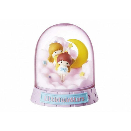 A pink snow globe containing two small figurines, one yellow and one pink, sitting on clouds and gazing at the moon.