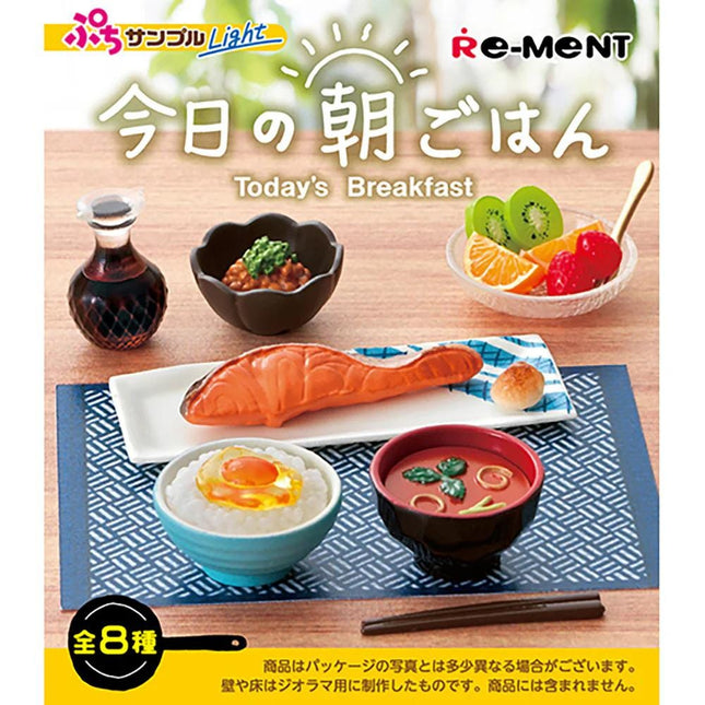 The image is a vibrant and colorful display of various breakfast dishes, including a bowl of rice, a bowl of soup, a plate of fish, and a bowl of fruit. The dishes are arranged on a table, creating an inviting and appetizing scene.