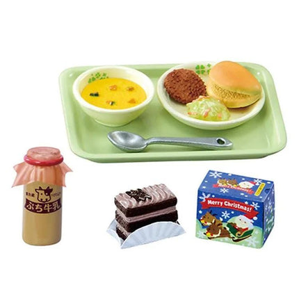 a tray with various food items, including a bowl of soup, a sandwich, a cake, and a jar of sauce.