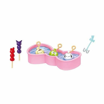 A pink heart-shaped container with three small animal figurines inside, along with a blue toy shovel.