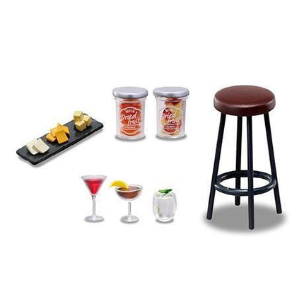 various items, including a stool, a tray of cheese, two bottles, two glasses, and two cocktails.