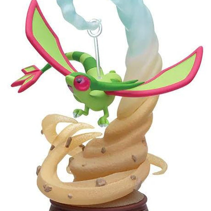 A figurine of a dragon-like creature with green and pink colors, wings, and a tail, suspended in mid-air.