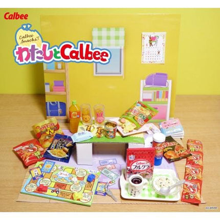 The image is a colorful display of various snacks and drinks, including chips, candy, and beverages, arranged on a table or counter.