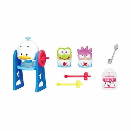 A collection of colorful toy figurines and accessories, including a duck-like character, a green monster, and various other playful elements.
