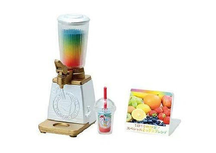 A colorful blender with a straw, a small plastic cup, and a picture of various fruits on a stand.