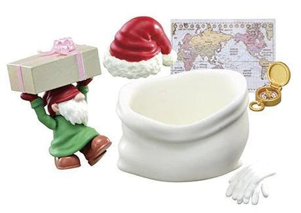 A gnome figurine is holding a gift box, and there is a world map in the background.
