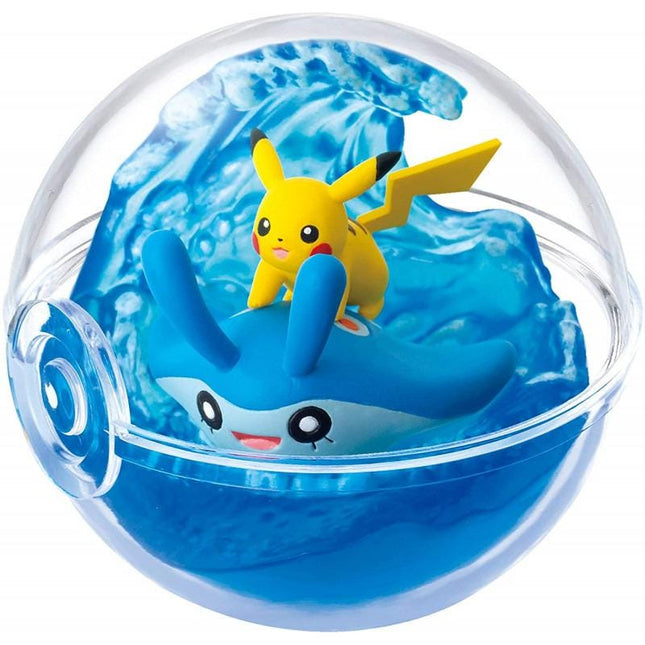 A figurine of Pikachu riding on top of a blue sea creature, likely a stingray or octopus, inside a transparent ball.