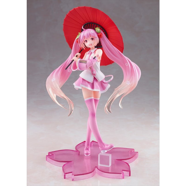 Anime character figurine with pink hair and a red umbrella on a gray background