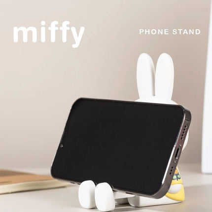 Phone stand shaped like a rabbit with 'miffy' branding on a light background