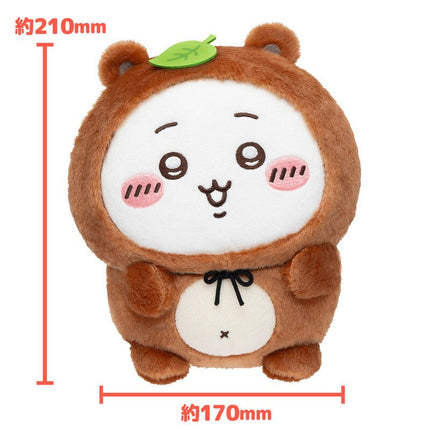 Tanuki plush toy with tan fur, white belly pouch, and green leaf on top