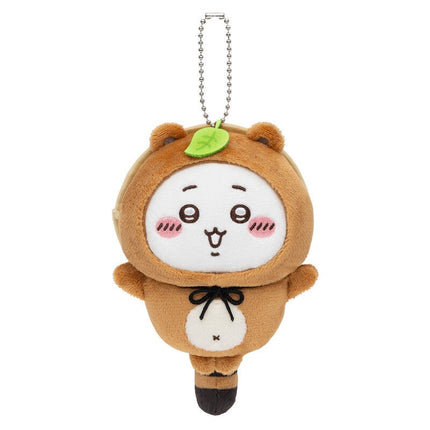 Tanuki keychain plush with silver chain, tan fur, white belly pouch, and green leaf on top