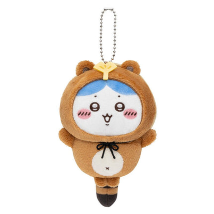 Tanuki keychain plush with silver chain, tan fur, white belly pouch, and blue head panel with yellow bow