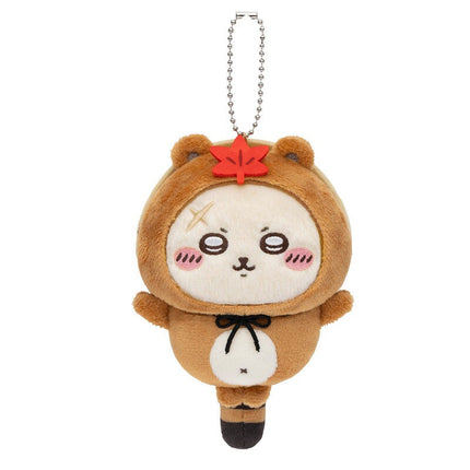 Brown tanuki plush keychain with red emblem, stitched face, silver ball chain