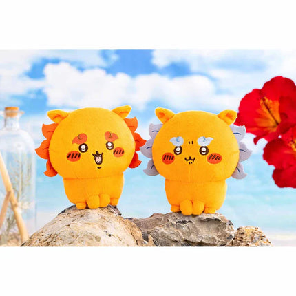 Two orange plush toys with cat-face embroidery and wavy side tufts.