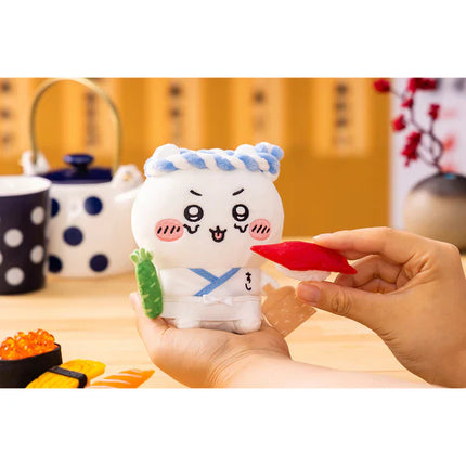 Handheld sushi trainee plush character with blue hat, white apron, red topping