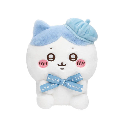 White sitting plush toy with blue ear muffs and blue scarf