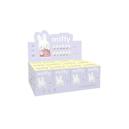 Display box of Miffy toys with a purple background and Miffy character on top.