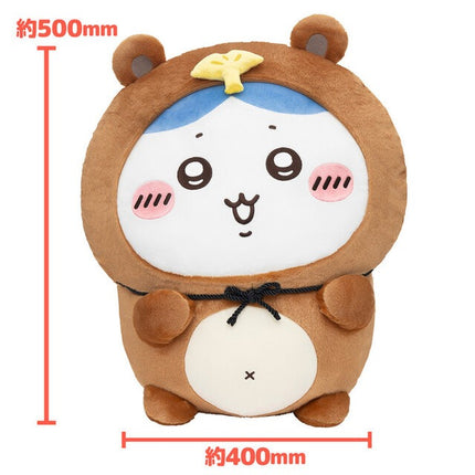 Tanuki plush toy with tan fur, white belly pouch, and blue head panel with yellow bow