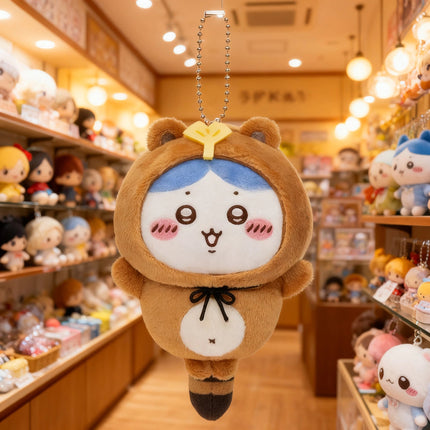 Tanuki series plush keychain, brown mascot with white face and yellow cap on head