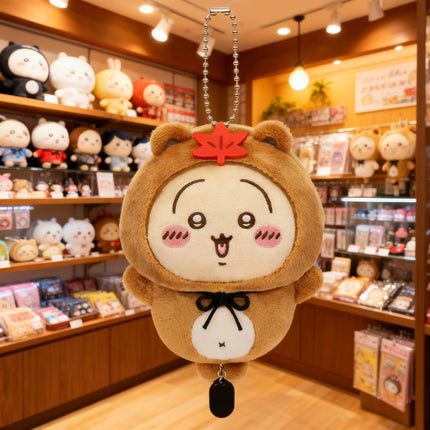 Tanuki series plush keychain, brown round character with red leaf and white face