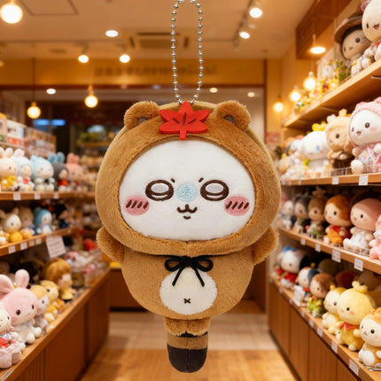 Tanuki series plush keychain, brown mascot with white face and red leaf on head