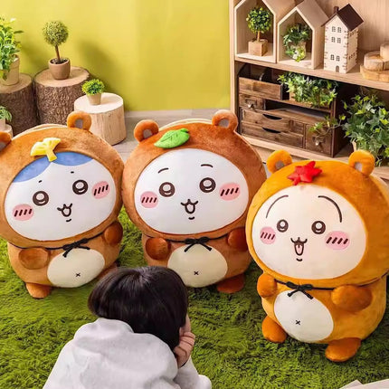 Tanuki series plush toys, three brown characters with white faces, bows, and side pouches