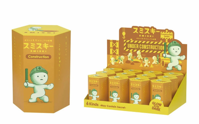 Smiski Construction series blind box packaging with small green toy figure, under construction scene