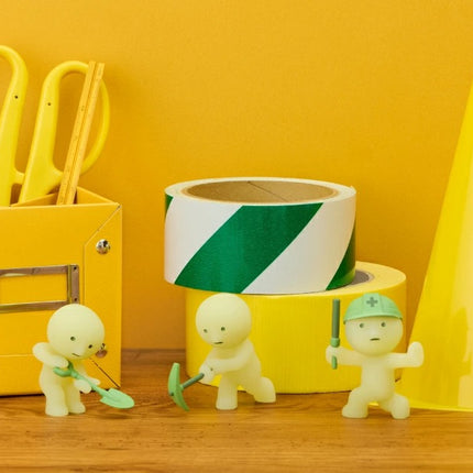 Smiski Construction Series blind box figures beside yellow tool organizer and cone