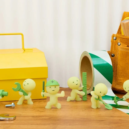 Smiski Construction Series blind box figures with yellow toolbox, hand tools, and green roll