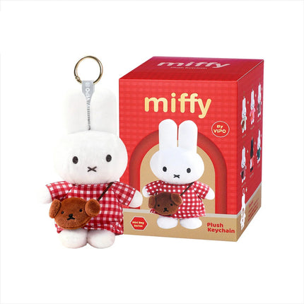 Miffy plush keychain with red checkered dress and brown bear toy, next to its packaging box on a white background.
