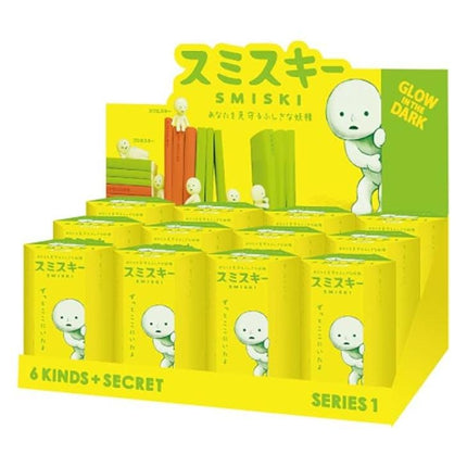 A display of Smiski figurines, with a sign that reads "Glow in the Dark" and "6 Kinds + Secret".
