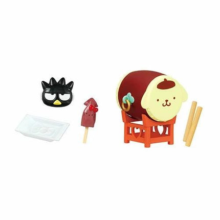 a variety of colorful and whimsical objects, including a toy drum, a toy cat, a toy rocket, and a toy plate.