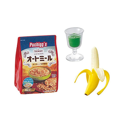 a bag of oatmeal, a glass of a green liquid, and a banana.