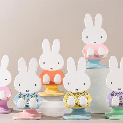 a collection of colorful ceramic figurines of the character Miffy, a popular children's character from the Japanese television series "My Little Pony". The figurines are arranged in a row, showcasing the different colors and designs of the character.
