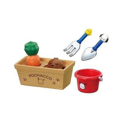 a wooden box with a toy carrot and a toy shovel inside, along with a red bucket and a toy shovel.