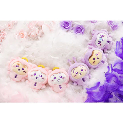 Angel baby plush mascots set, pink and purple characters on white bedding